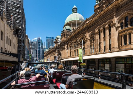SYDNEY, AUSTRALIA - NOVEMBER 8: People look at the sights of Sydney by Hop-on Hop-off bus - go along the main George street at November 8, 2014 in Sydney, Australia.