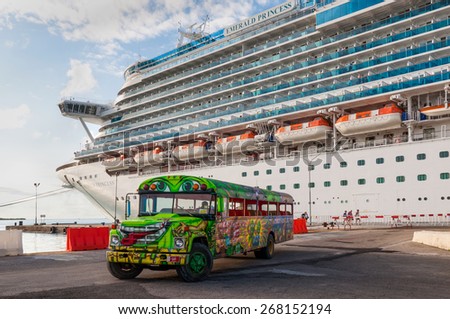 ORANJESTAD, ARUBA - DECEMBER 01: A Princess Cruise Line cruise ship docked in Oranjestad at December 01, 2011. A colorful tour bus waiting for the next group of tourists for a fun island tour.