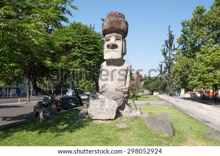 SANTIAGO, CHILE - DECEMBER 2: The statue of this Moai sits on Alameda in downtown Santiago de Chile at December 2, 2012 . Until today rock sculptures from eastern islands remain a mystery.