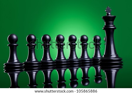 the leader and his team - black king standing in front of his black pawns