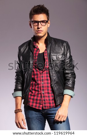 Handsome young man in a t-shirt, jeans and a leather jacket