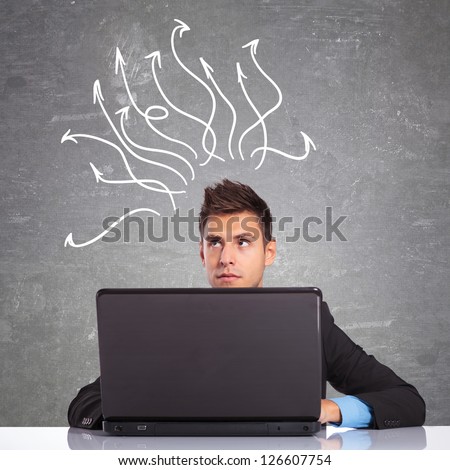 young business man using the laptop computer is thinking at hot to resolve some problems