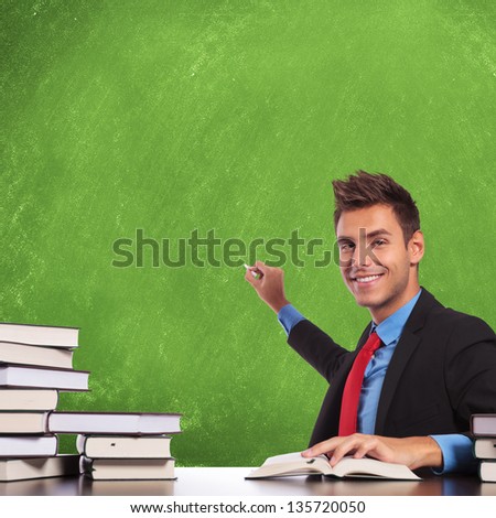business man sitting at desk and preparing to write concepts on a blank board , with a smile on his face