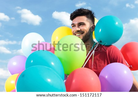 casual man with balloons all over him