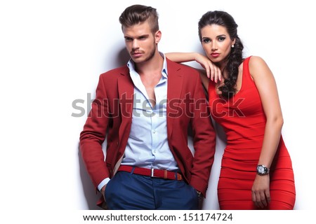 Young Fashion Man And Woman Against White Wall, Posing For The Camera
