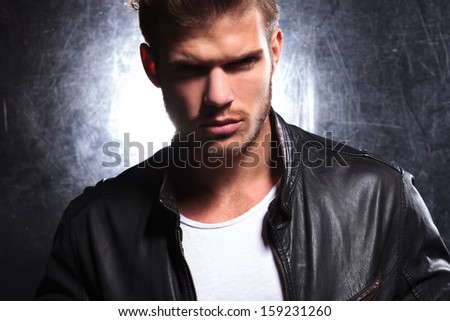 killer look of a young macho man in leather jacket