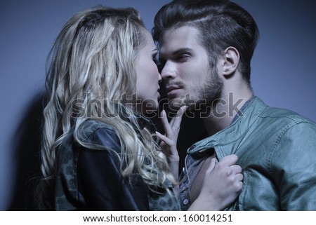 closeup picture of a young couple looking at each other with passion and getting ready to kiss