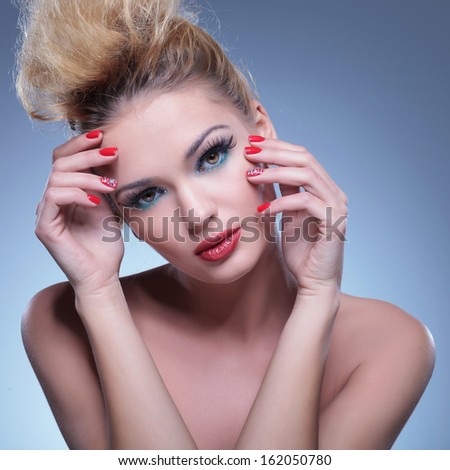 classic pose of a beauty woman with hands on face, looking at the camera
