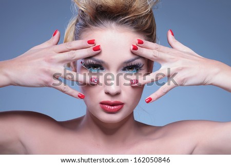 closeup picture of a young beauty woman with hands framing her face and eyes