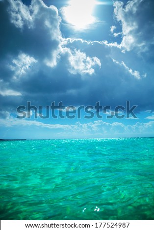 sun in the sky and beautiful waters of the caribbean sea near the saona island