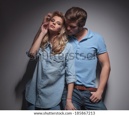 man playing with his girlfriend in a sexy pose , studio picture