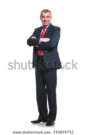 full length picture of a mid aged business man smiling with his arms crossed. isolated on a white background