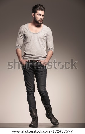 young male model with beard in a fashion pose looking to his side