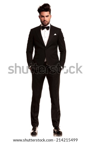 fashion man in tuxedo standing with hands in pockets, full body picture on white background