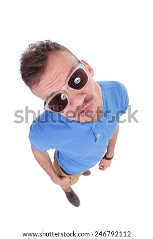 top view of a casual young man biting his lips. on a white background
