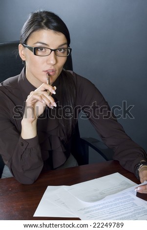business woman on desk reading