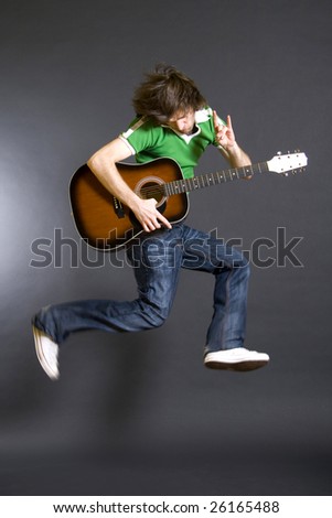 passionate guitarist jumps in the air