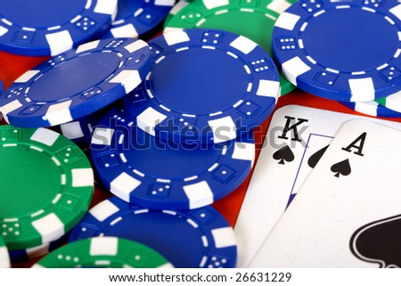 ace king of spades and poker chips