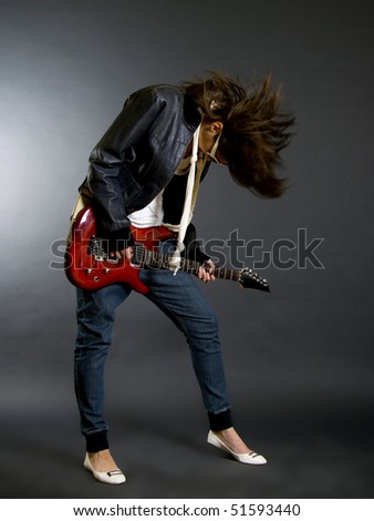 stock photo passionate headbanging woman guitarist playing an electric 