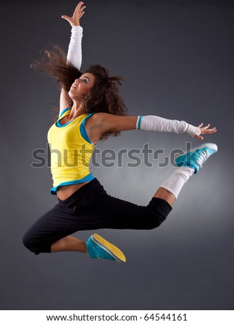 stylish and cool looking break dancer jumping in studio