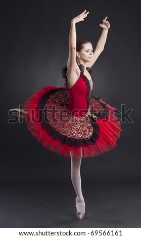 picture of a beautiful ballerina posing in a red tutu