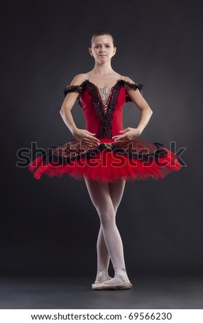 Professional ballet dancer posing on black background