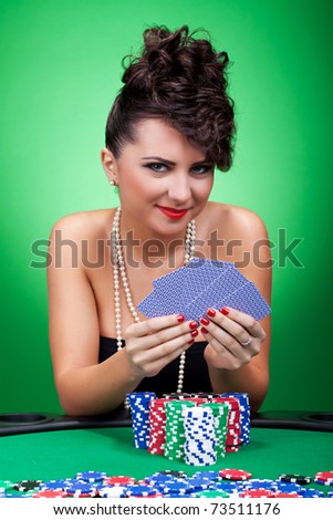 The girl in a black dress with five cards on a green background