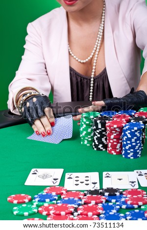 closeup picture of a woman pushing all in at a poker table
