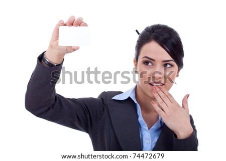 Portrait of a surprised young woman holding a small blank card against white background