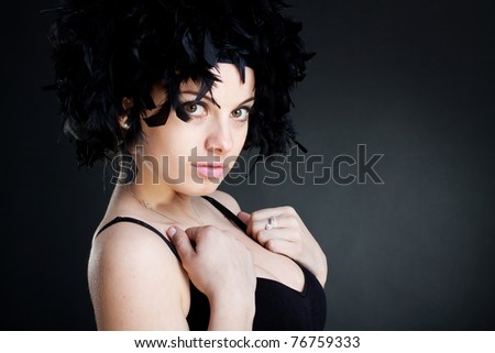 Closeup of a beautiful woman wearing a black feather wig