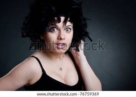 Closeup of a surprised woman with a black wig
