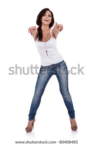Full body young woman in casual clothes pointing at you isolated over