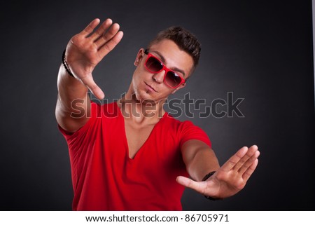 Handsome man showing framing hand gesture - isolated on white