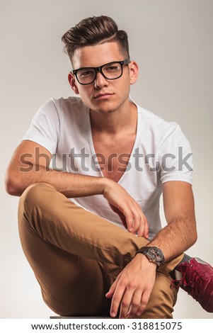 close up with smart man wearing glasses and looking forward at the camera