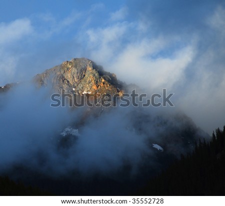 First light breaks on a cold foggy day in the Colorado Rockies