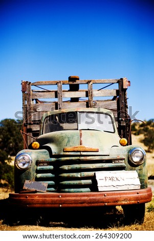 old green rusted truck in field