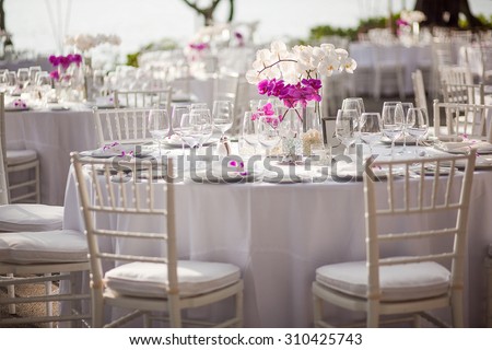 Orchid centerpiece at an outdoor event or wedding reception