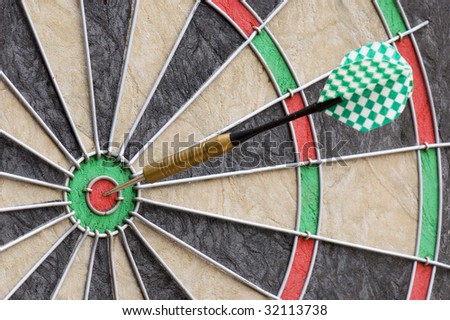 a dartboard with a dart hitting the bullseye in the center of the board dart board