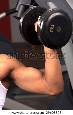 a close up of a man\'s arm as he lifts weights