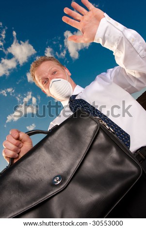 a man who is afraid of getting sick holds his briefcase