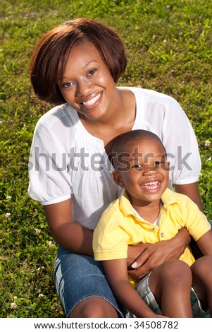 a happy african american mom poses with her son