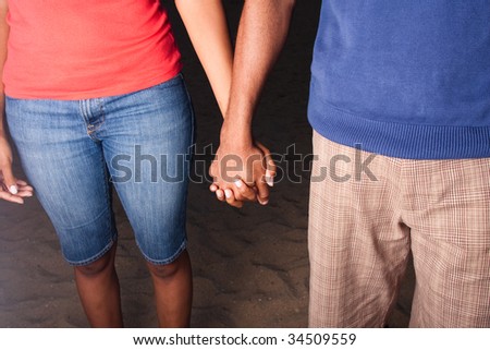 a happy african american couple holding hands = close-up shot