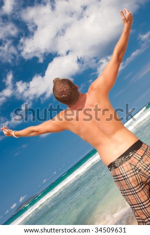 a man celebrates the fact that he is on a beach
