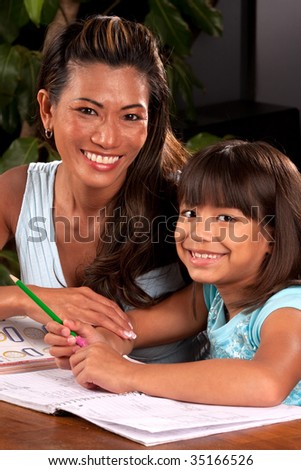 a mom helps her daughter with homework