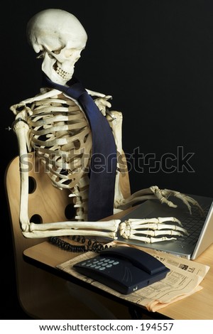 stock-photo-a-skeleton-works-on-a-laptop