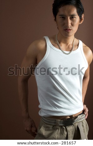 A muscular asian male model in a white vest over a brown background
