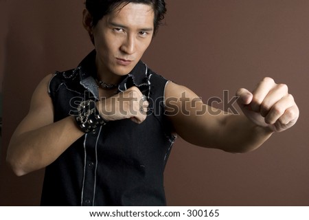 An asian male model throws a punch