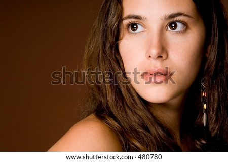 A naturally beautiful young woman on a brown background