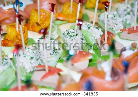 A tray of party food on cocktail sticks