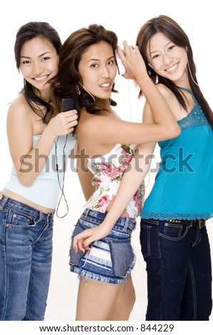 Three attractive young women listening to music on their mp3 players